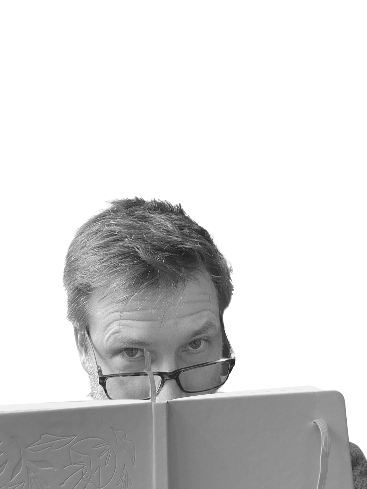 Picture of German marketing translator Jan Fredriksson hiding his mouth behind a copybook 